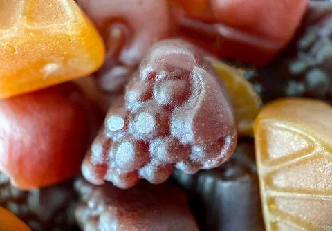 Close-up texture of yellow, red and pink multivitamin tablets in form of fruits Stock Photos