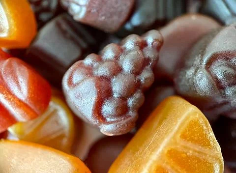 Close-up texture of yellow, red and pink multivitamin tablets in form of fruits Stock Photos
