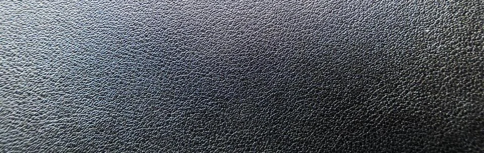 Close-up of a textured black surface, showcasing subtle patterns and depth. 스톡 사진