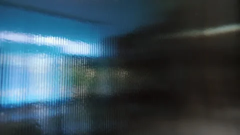 Close up of textured blue glass wall diffusing interior light, distorting v.. Video stock 314607615
