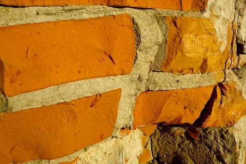 Close-up of Textured Brick Wall Showcasing Vibrant Orange and Gray Tones in.. Stock Photos