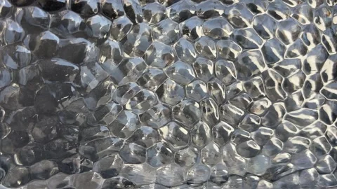 Close-Up of Textured Bubble Glass with Changing Light Reflections Stock Footage 331897591