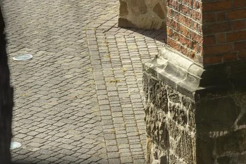 A close-up of a textured cobblestone path intersecting with brick and stone Stock Photos