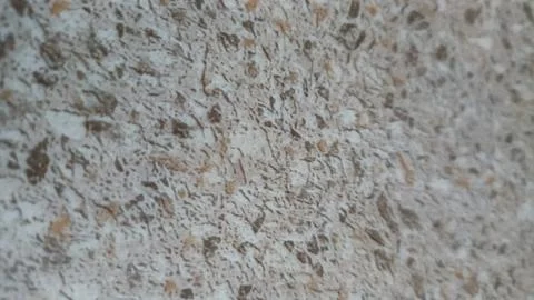 A close-up of a textured composite material surface with beige and brown hues Stock Photos