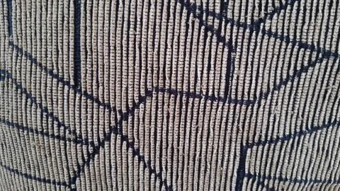 Close up of textured fabric featuring vertical lines and patterns 스톡 사진