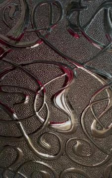 Close up of textured glass pattern with dark colored reflections. Stock-Fotos