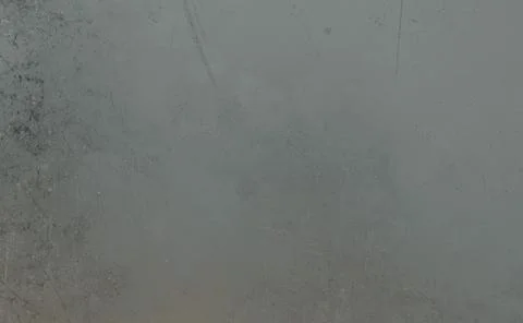 Close-up of a textured gray surface, showing clear signs of wear Illustrazione stock