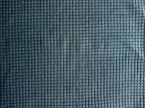 Close-up of textured grey performance fabric weave with intricate grid patter Stock Photos