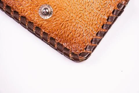 Close-up textured leather wallet corner, intricate stitching, metallic rivet, Stock Photos