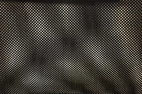 A close-up of a textured mesh pattern with contrasting circles and lines, Stock Photos