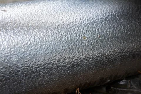 Close-up of textured metallic silver pipe with dimpled surface insulation Stock Photos