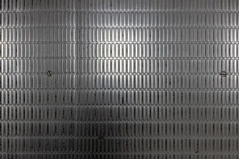 Close-Up of Textured Metallic Surface with embossed pattern and Screws Stock Photos