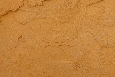 Close up of textured ochre wall surface Foto stock