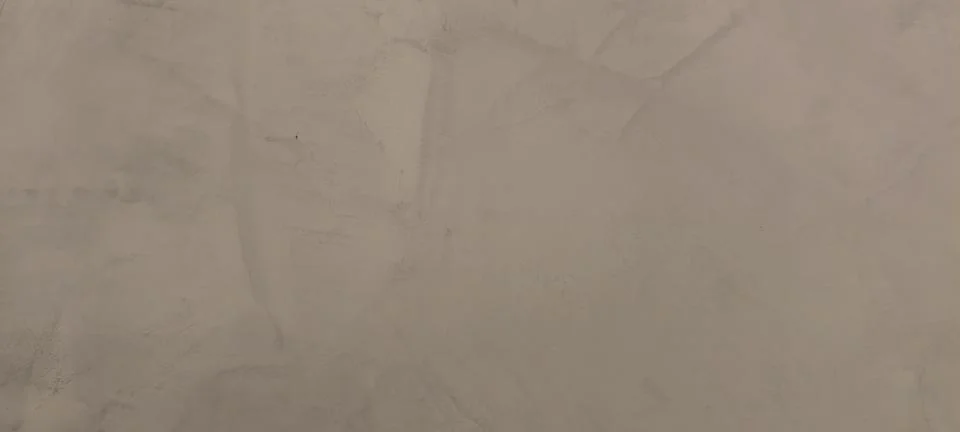 Close‑up of a textured plaster wall in light beige tones 写真素材