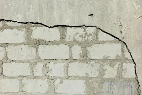 Close-up of a Textured Plaster Wall Showing Cracks and Variations in Color Stock Photos