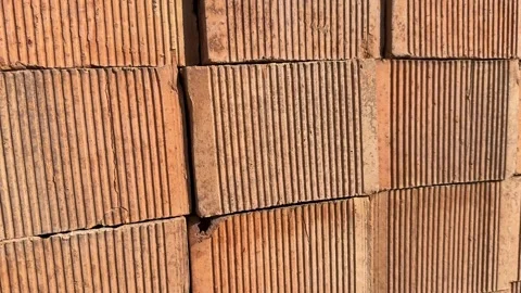 Close-up of textured red clay bricks for construction background or masonry.. Stock Footage 330897601