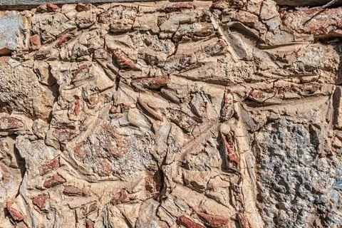 Close-up of a textured stone wall, showcasing natural rock formations 스톡 사진