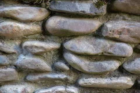 Close-up of a textured stone wall, showcasing the natural beauty of the roc.. Stock Photos