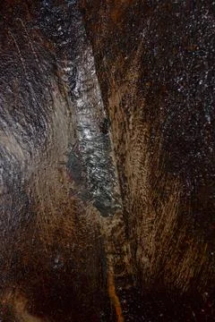 Close Up of Textured Surface with Vertical Crevice and Light Reflection Stock Photos