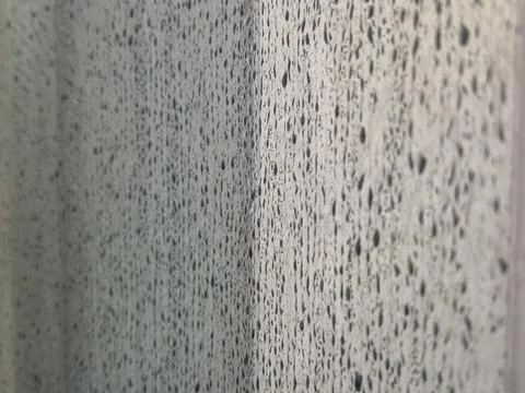 A close-up of a textured surface with visible droplets of water, creating an Stock-Fotos