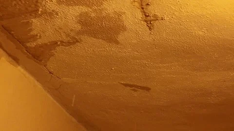 Close-up of textured wall with water stains and cracks, showing signs of damage. Stock Footage 336120261
