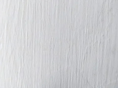 Close-up of a textured white surface with vertical lines. Stock Photos