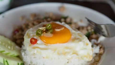 Close Up of Thai Basil Minced Pork with Fried Egg and Rice Stock Footage 348049499