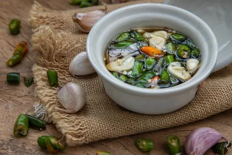 Close-up of Thai chilli fish sauce and ingredients with thai green. Stock Photos