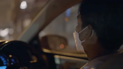 Close up of Thai driver on service at night, wearing face mask for healthcare Stock Footage 211371245