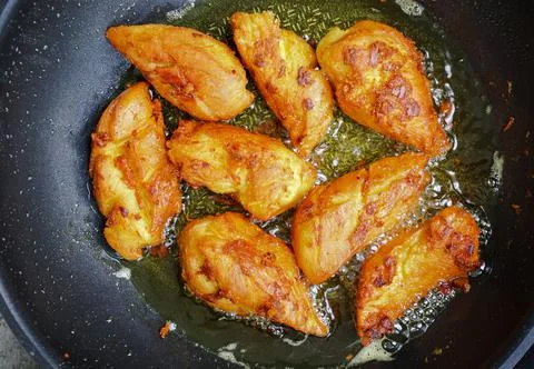 Close-up Thai fried chickens with tumeric on a pan Stock Photos
