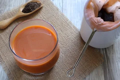 Close up of Thai hot tea with tea powder on the table. Thai tea Stock Photos