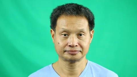 Close up Thai man with green background, in studio Chiangmai Thailand Stock Footage 140428068