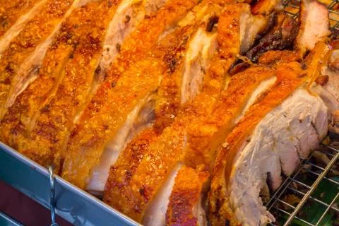 Close up Thai roasted crispy pork on banana leaf Stock Photos
