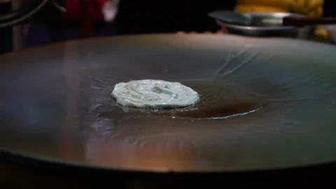Close up of Thai roti fried on pan, slow motion Stock Footage 111014560