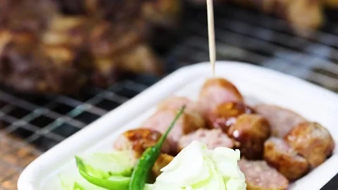 Close Up of Thai Sausage Served with Cabbage and Green Chili Stock Footage 327831954