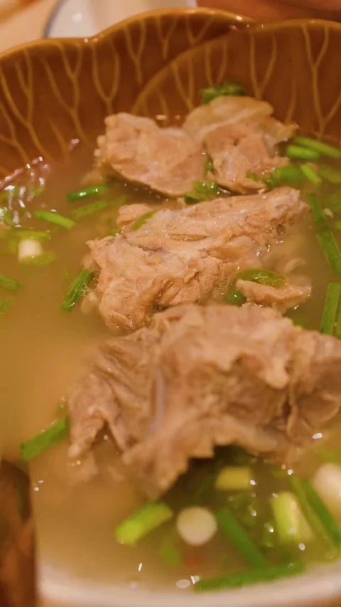 Close Up of Thai Spicy Pork Rib Soup in Ceramic Bowl Video stock 346345975