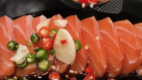 Close-up of Thai-Style Spicy Marinated Salmon Sashimi (Salmon Zaap) with Fresh C Stock Footage 333489725