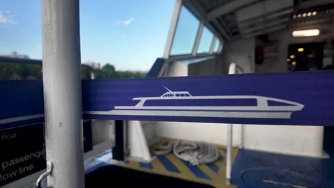 Close-up of a Thames Clipper ferry logo printed on a blue retractable barrier Stock Footage 342198302