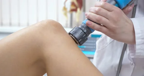 Close-up of therapist Doctor doing shock wave therapy on Knee for a Fit Sporty Stock Footage