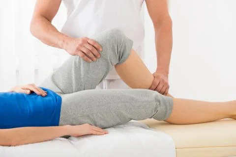 Close-up Of Therapist Hand Doing Knee Massage In Spa Saloon Stock Photos