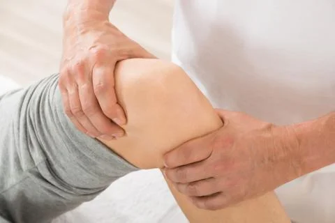 Close-up Of Therapist Hand Doing Knee Massage In Spa Saloon Stock Photos