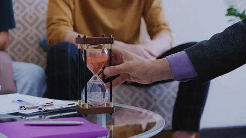 Close Up of Therapist Hands Resetting Sand Timer Stock Footage 339611976