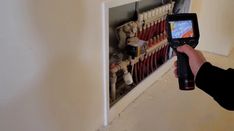 Close-up. Thermal imaging. The engineer checks the pipe with a thermal imager Stock Footage 129070196