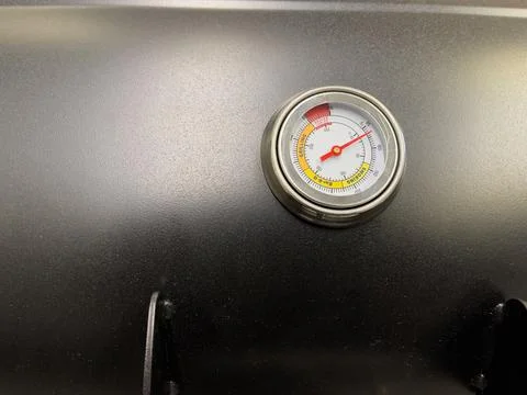 Close-up of the thermometer on the grill lid. Stock Photos