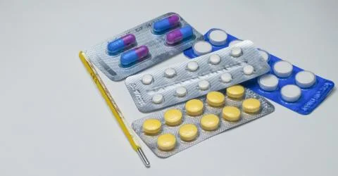 Close up of thermometer, tablets and capsules Stock Photos