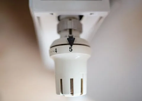 Close-up of a thermostatic temperature control valve on a radiator. Stock Photos