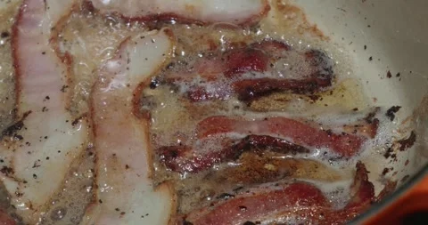 Close-up of Thick-Cut Bacon Sizzling in its Own Fat Stock Footage 318857762
