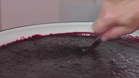 Close Up of Thick Fruit Jam Bubbling in a Large Enamel Cooking Pot Stock Footage 339650659