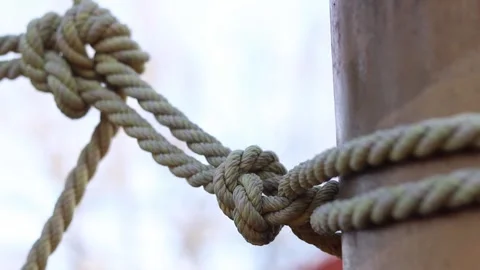 Close-up of thick light-colored ropes tied into a knot. 4 Stock Footage 331502216