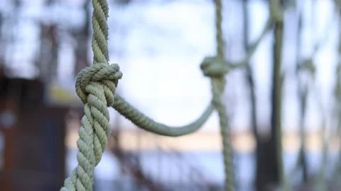 Close-up of thick light-colored ropes tied into a knot Stock Footage 331502219